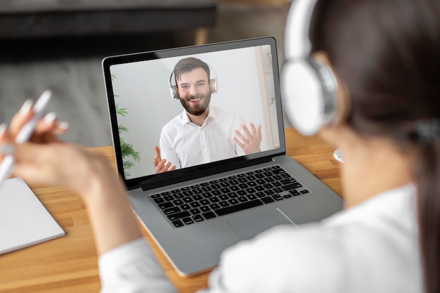 Free photo close up woman videocalling employee