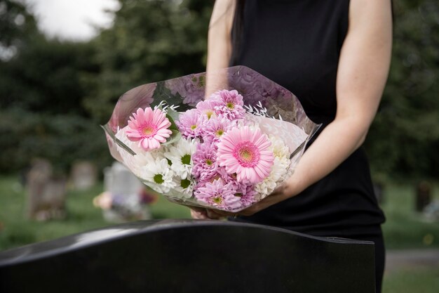 Close up on woman visiting the grave of loved one