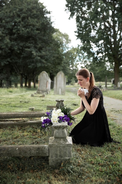 Close up on woman visiting the grave of loved one