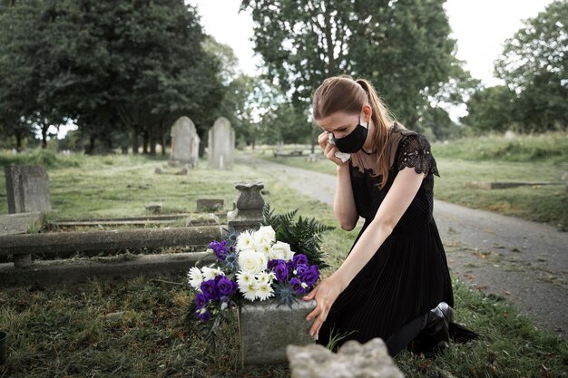 Close up on woman visiting the grave of loved one