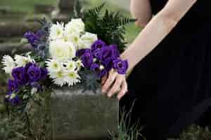 Free photo close up on woman visiting the grave of loved one