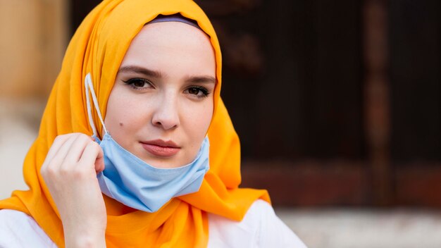 Close-up woman wearing blue mask