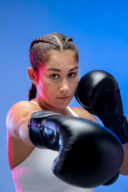 Close up woman wearing boxing gloves