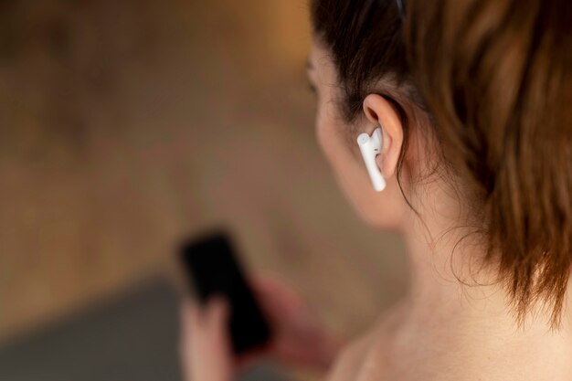 Close up woman wearing earphones