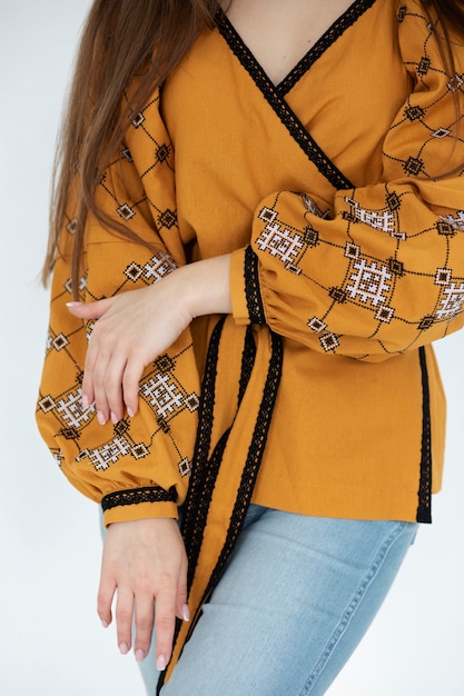 close up woman wearing embroidered  shirt