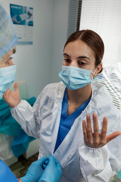 Close up woman wearing hazmat suit