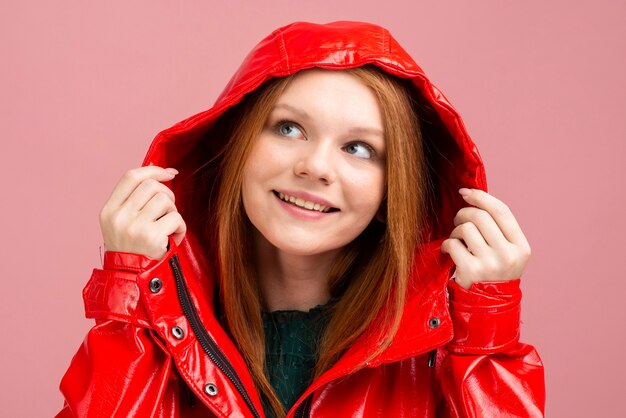 Close-up woman wearing red rain jacket