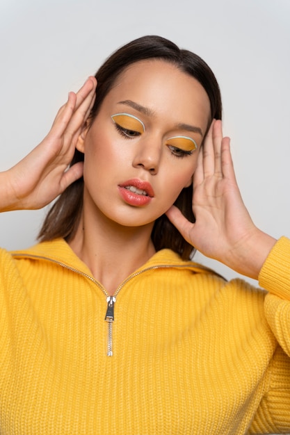 Close up woman wearing yellow eyeshadow