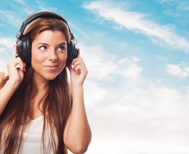 Close up of woman, who listening music in headphones