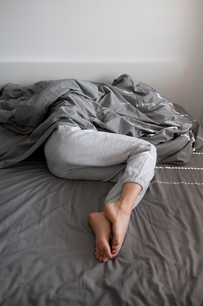 Close up woman with anxiety under blanket