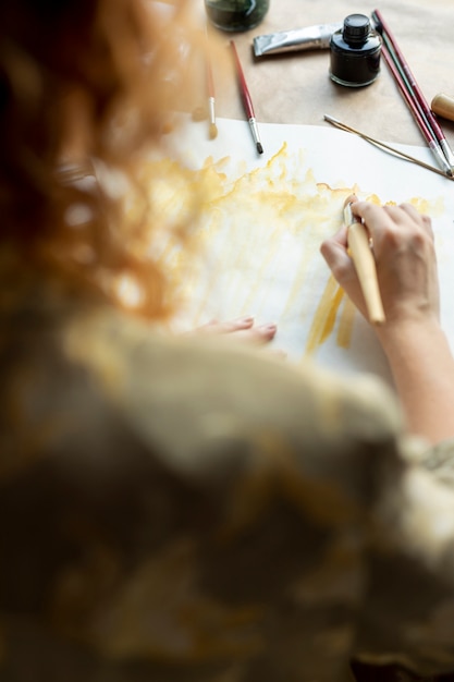 Close-up woman with brush painting