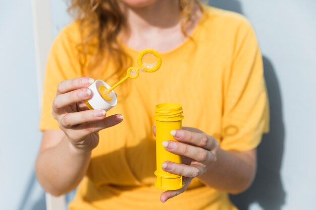 Close-up woman with bubbles maker