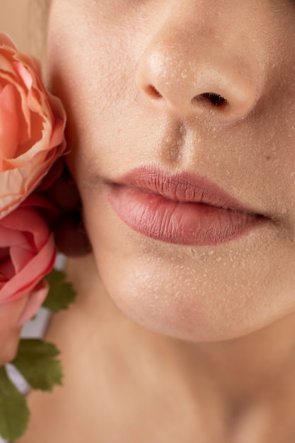 Close up woman with clear skin and flower