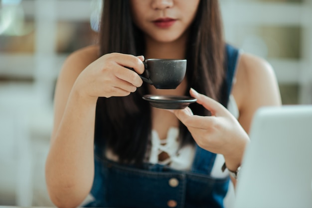 Close up woman with cup coffee in the cafe  