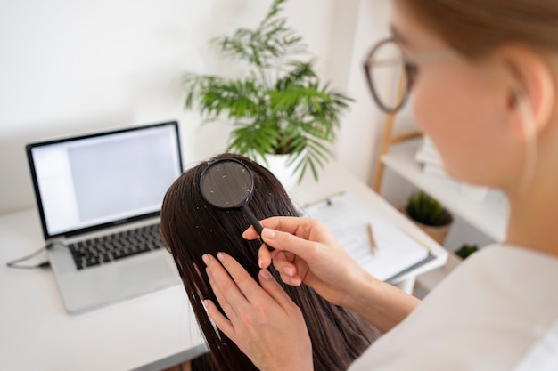 close up woman with dandruff at clinic