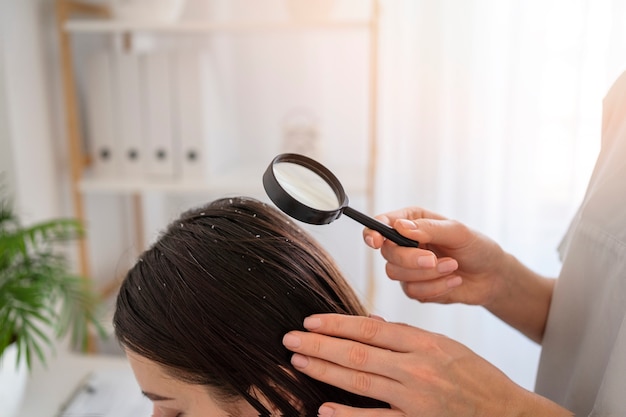 Close up woman with dandruff at doctor