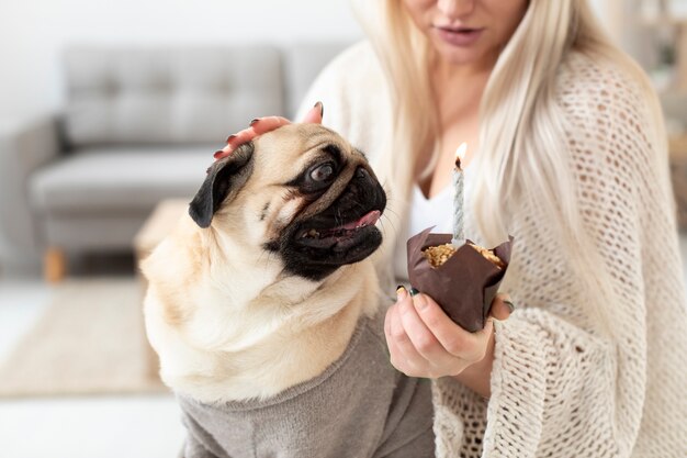 Close up woman with dog and muffin
