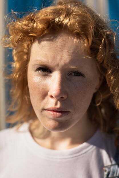 Close-up woman with freckles looking at the camera