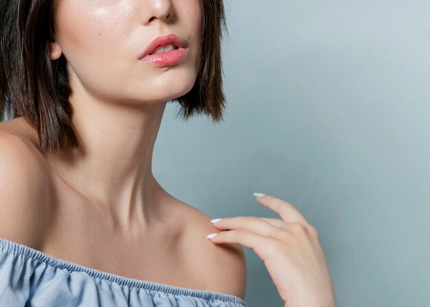 Close-up of woman with hand and ruffle top