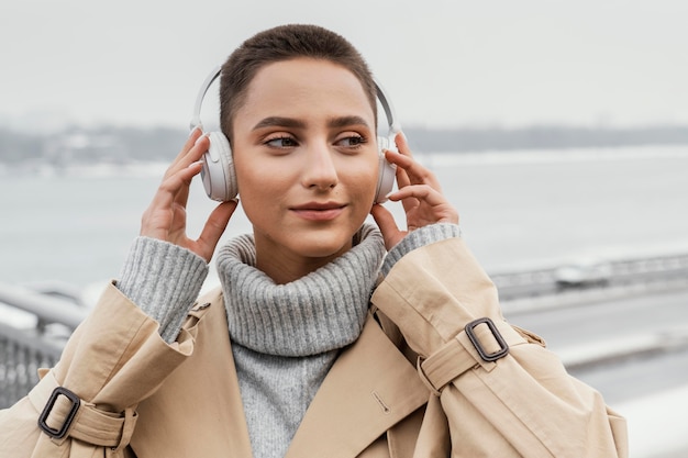 Free photo close-up woman with headphones outside