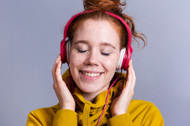 Close-up woman with headphones and wide smile