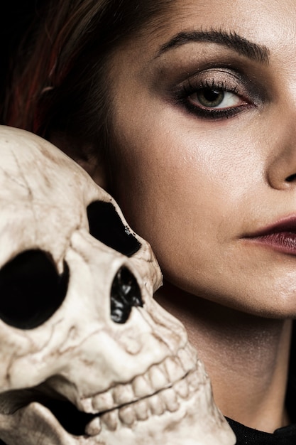 close-up woman with human skull