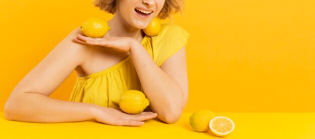 Close-up woman with lemons on her body
