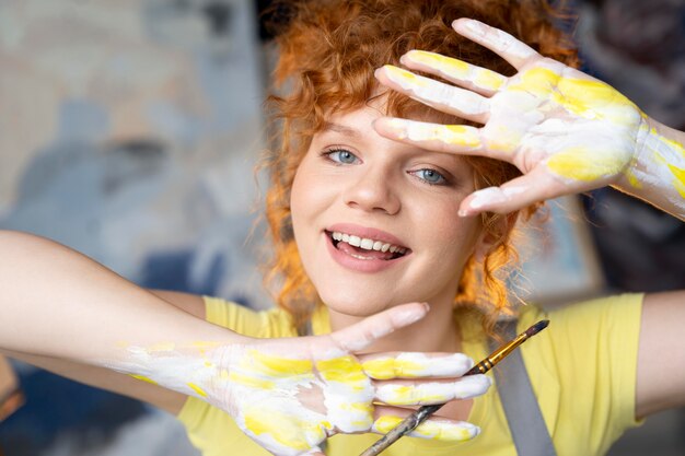 Close up woman with paint on hands