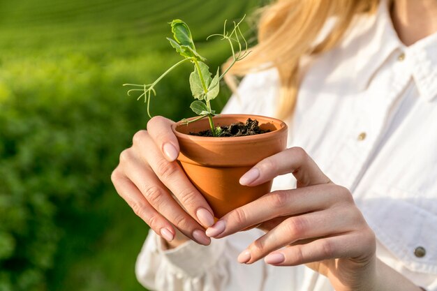 close-up woman with plant pot