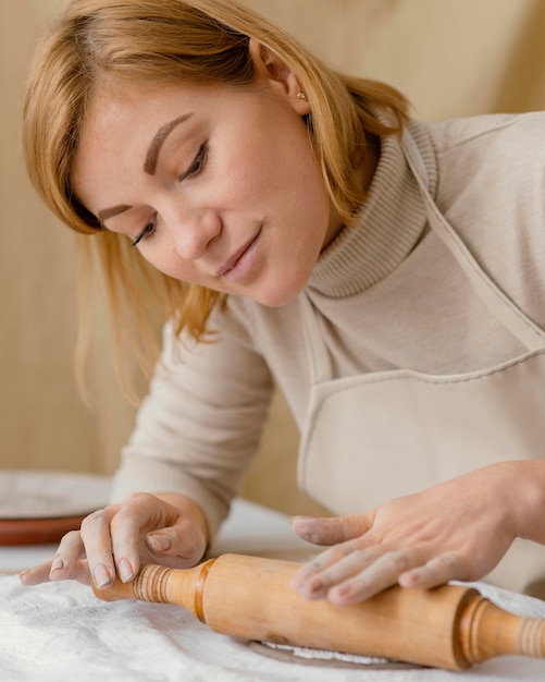 Close-up woman with rolling pin
