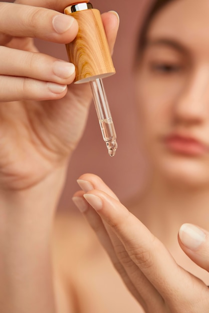 Close up woman with serum