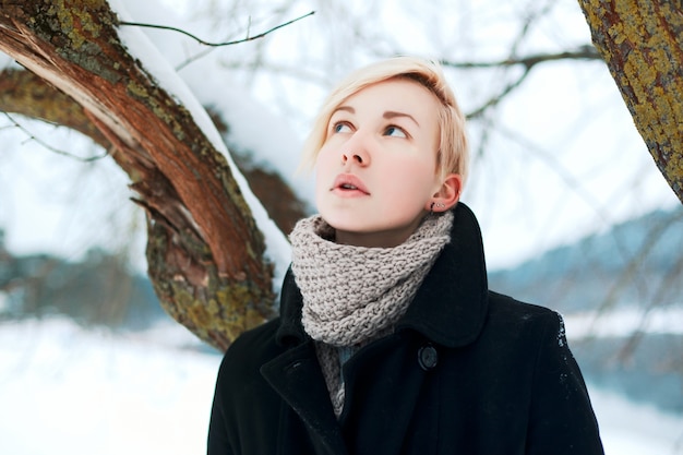 Close-up of a woman with short hair in the snow