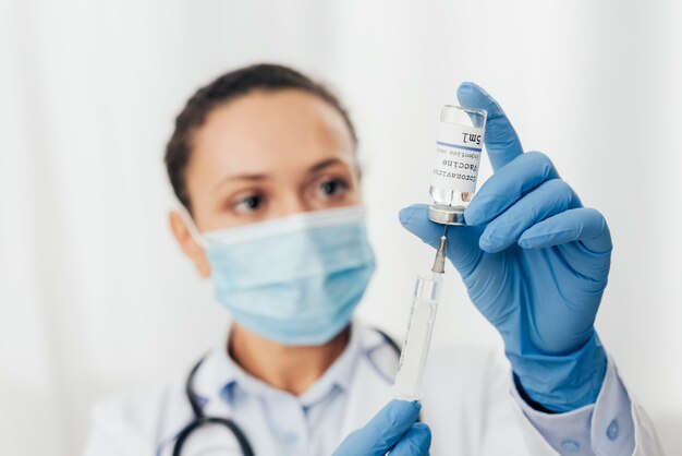 Close-up woman with syringe and serum