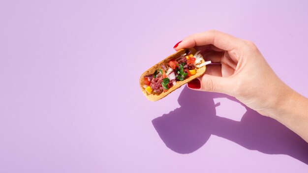 Close-up woman with taco, copy-space and purple background