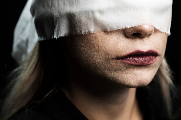 Close-up of woman with white blindfold