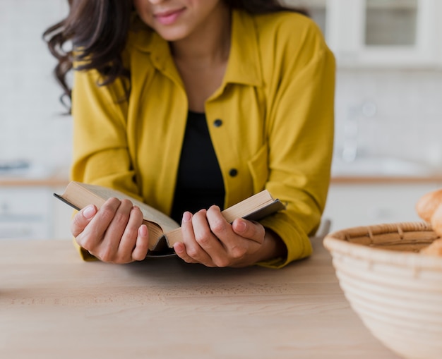 Close-up woman with yellow blouse and book