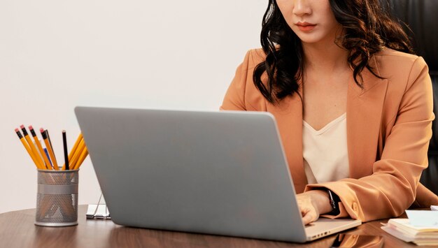 Close-up woman working on laptop