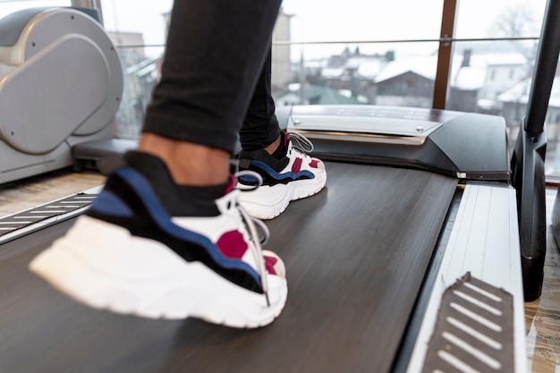 Close-up woman working on treadmill