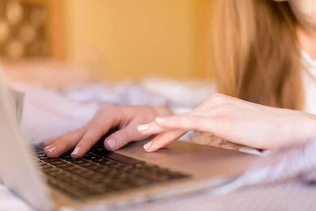 Close-up of woman working with her laptop