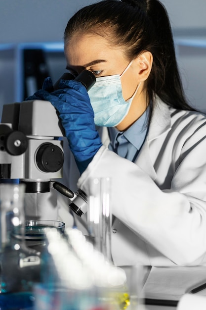 Close up woman working with microscope