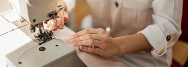 Close up woman working with sewing machine