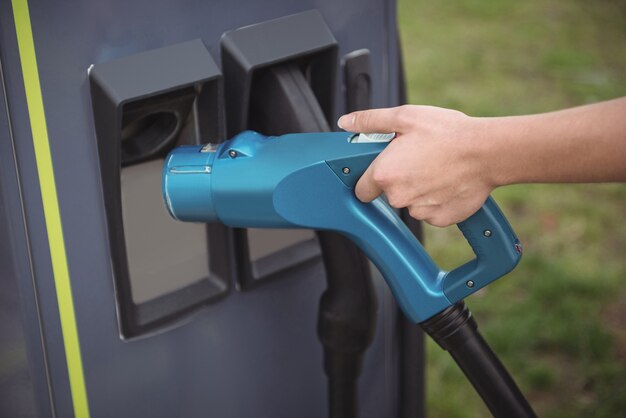 Close-up of womans hand using plug-in electric machine