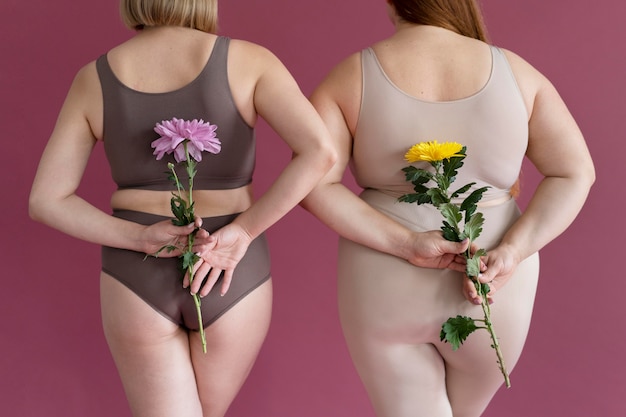 Close up women holding flowers back view