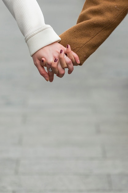Close-up women holding hands