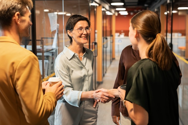 Close up women shaking hands at work