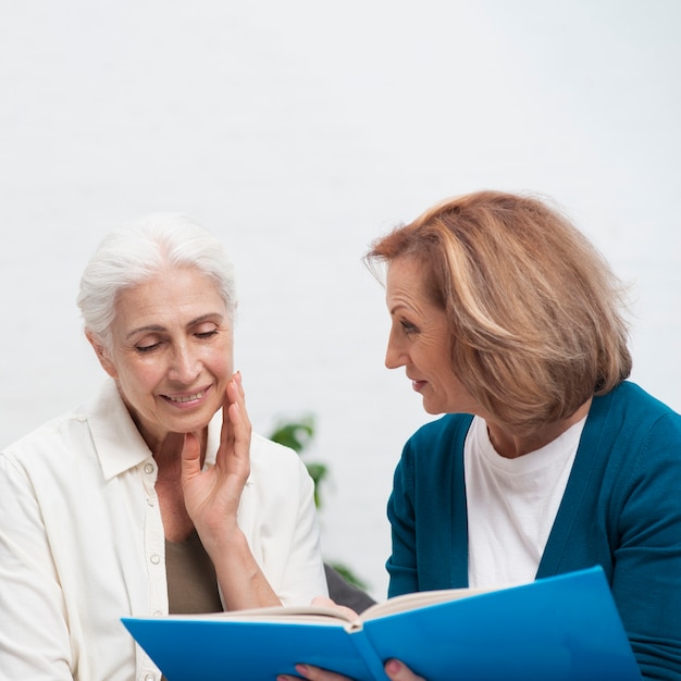 Close-up women together with a magazine