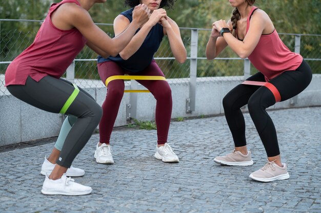 Close up women training with elastic bands