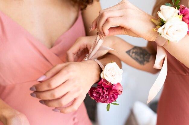 Close up women wearing flowers at bridal party