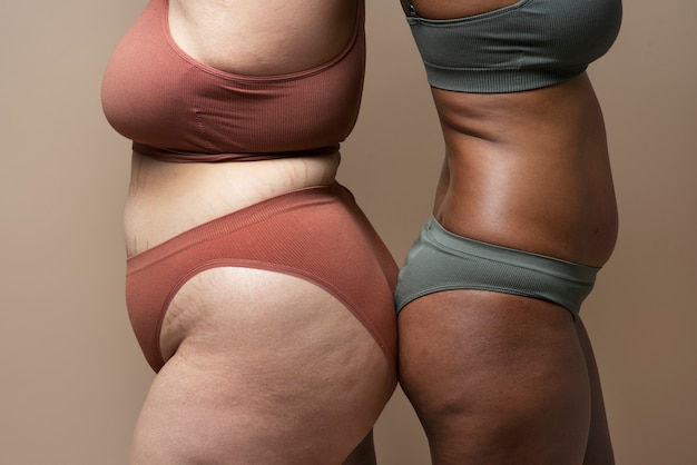 Woman in Underwear Touching Her Belly on White Background, Closeup