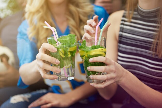 Close up of women with drinks having fun
